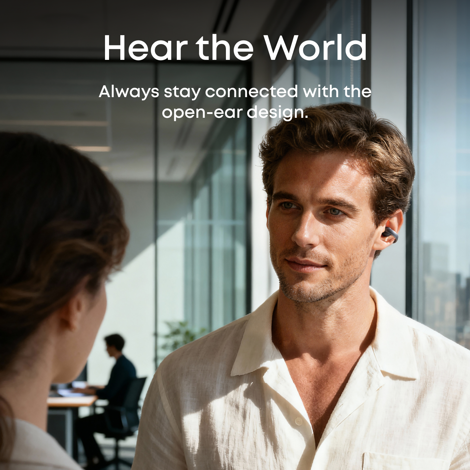 Anker AeroClip 2 everyday wear image, a man talking indoors while wearing the earbuds