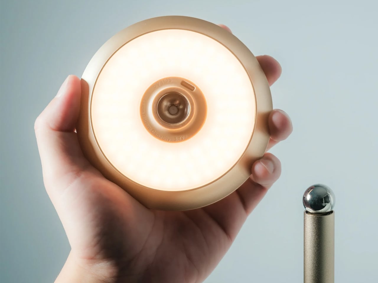 Infinite Solas Lamp detail 1, lighting head held in hand