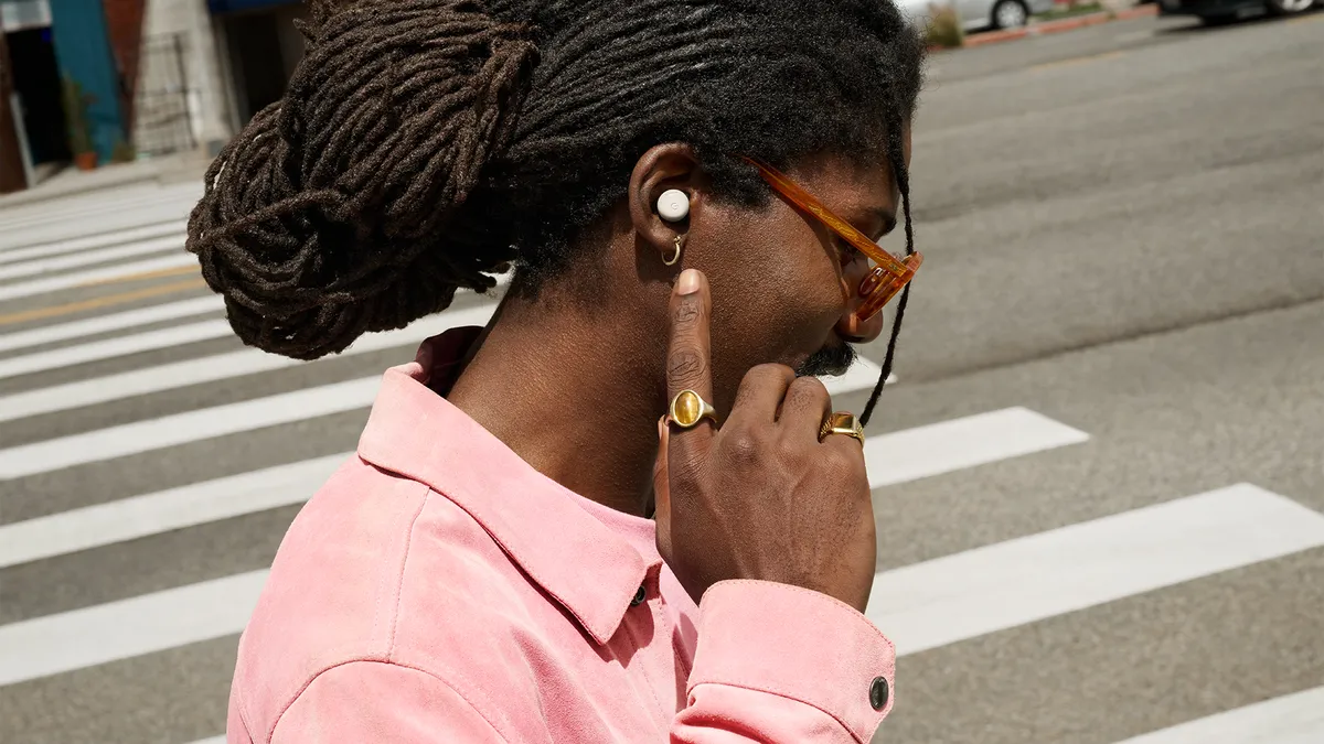 Pixel Buds Pro 2 close-up worn at a crosswalk